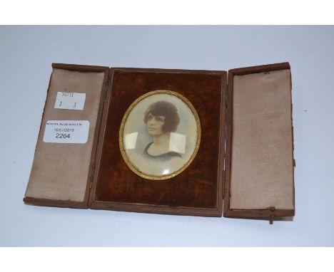 A cased portrait, hand painted of a 1920's / 1930's lady