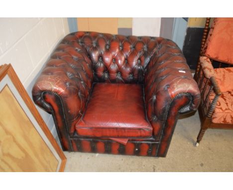 A red leather upholstered Chesterfield button back armchair 