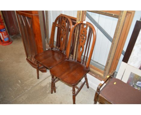 A pair of Old Charm stick and wheelback chairs 