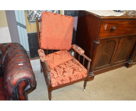 A mahogany bobbin turned armchair with floral upholstery