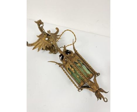 A Gothic style green glazed panel octagonal wall mounted lantern style light with winged dragon adjustable wall bracket mount