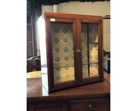 A 20th century mahogany tabletop showcase, two glazed doors enclosing single shelf, H70cm, W62cm, D27cm