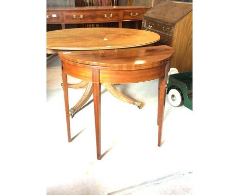 A George III inlaid mahogany demi-lune card table, the fold over top revealing baize lined playing surface, raised on square 