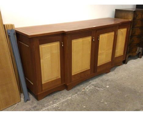 Michaela Huber, Cabinetmaker: A 20th century breakfront sideboard, with inlaid top over four panelled doors enclosing shelves