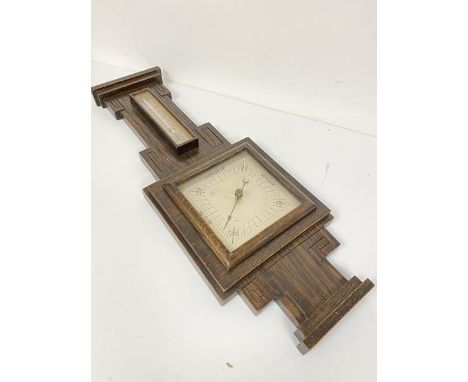 A 1920s/30s oak wall barometer complete with thermometer with silvered dial (64cm x 24cm)