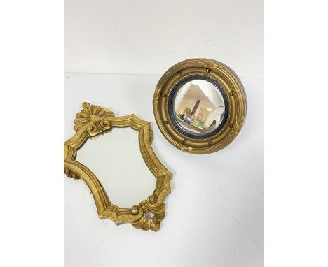 A rococo style giltwood miniature wall mirror (33cm) and a miniature convex ball pattern gilt composition mirror (18cm), with