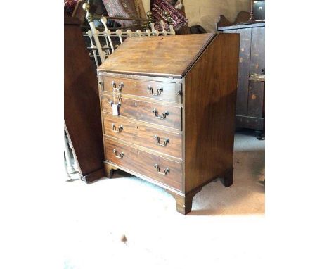 An Edwardian mahogany bureau, in the George III taste, the fall front revealing a baize lined writing surface, correspondence