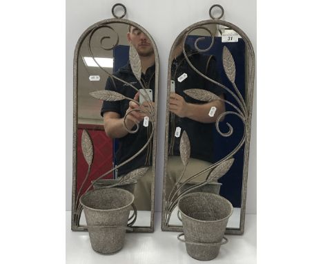 A small pair of garden mirrors with applied leaf decoration, each suspending a flower pot, 21 cm wide x 57 cm high including 