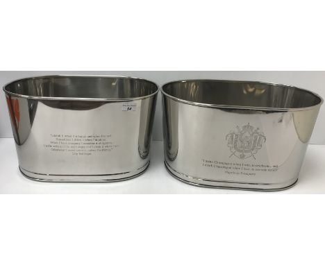 A pair of modern metal champagne coolers of tablet form inscribed "I drink champagne when I win to celebrate and I drink cham