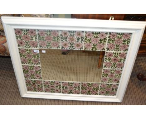 A large tile surround hanging wall mirror