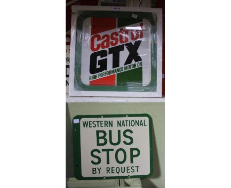 An enamel Western National bus stop sign with a framed Castrol sign