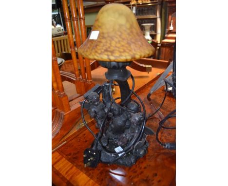 A reproduction figural table lamp in the form of two fairies beneath a large mushroom