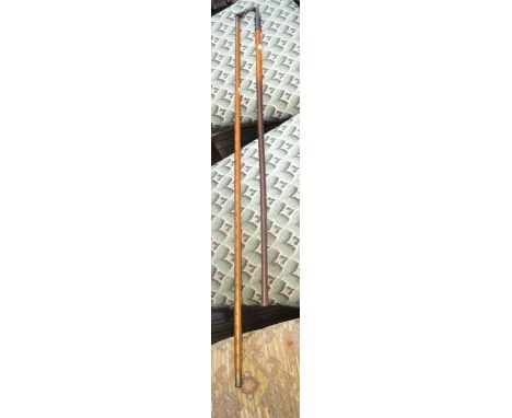 A wooden yard stick with brass finials and an ornate small walking stick, brass horses leg handle