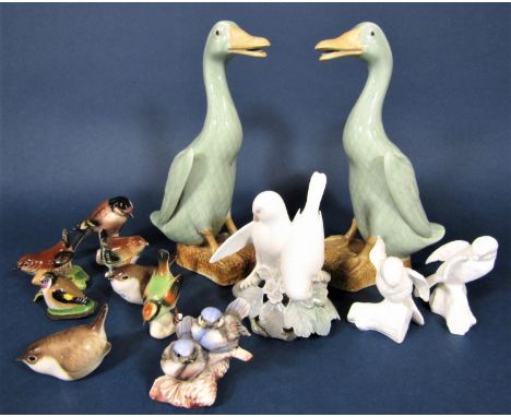 A pair of Chinese models of ducks with celadon type glaze, together with a Royal Copenhagen group of two white birds, a pair 