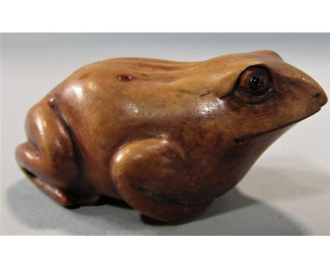 A small timber netsuke in the form of a frog 