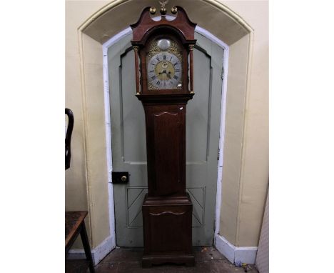 A Georgian oak longcase clock, the trunk with reeded and canted corners, the hood with column supports set beneath an arched 