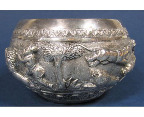 Impressive Indian T90 silver embossed bowl, with deep relief band of a hunting scene with lions, men on horse back, elephants