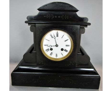 Victorian black slate mantle clock with enamelled dial Roman numerals and two train movement, the hinged case back enclosing 