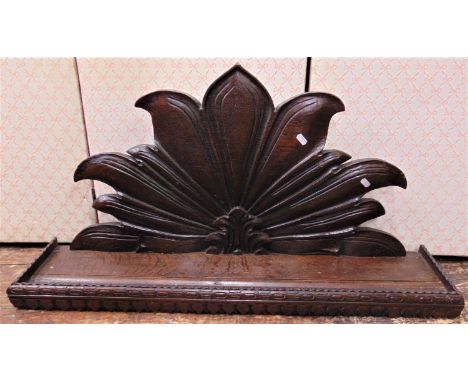 A Victorian oak rectangular hanging wall shelf, with raised repeating geometric carved borders, supported on a foliate bracke