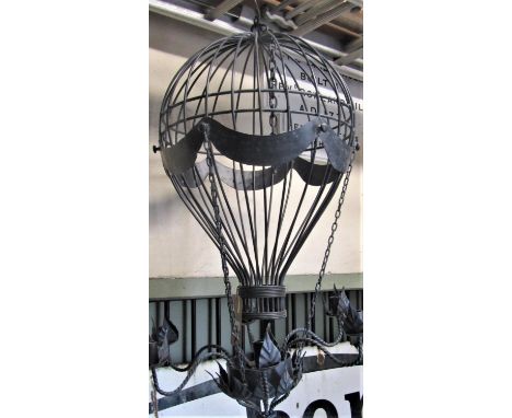 A novel contemporary cast metal hanging ceiling light in the form of a balloon with six rope twist branches and petal sconces