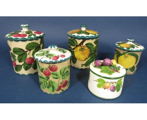A collection of Wemyss wares comprising two cylindrical jars and covers, 16cm tall approx, one with painted orange decoration