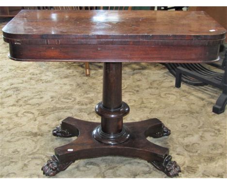 A 19th century rosewood veneered foldover top card table of rectangular form with rounded front corners, raised on a central 