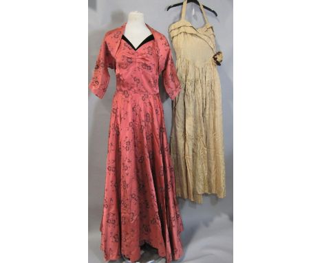 2 tailored vintage evening dresses. First is in patterned salmon satin trimmed with black velvet, with fitted bodice, (zip br