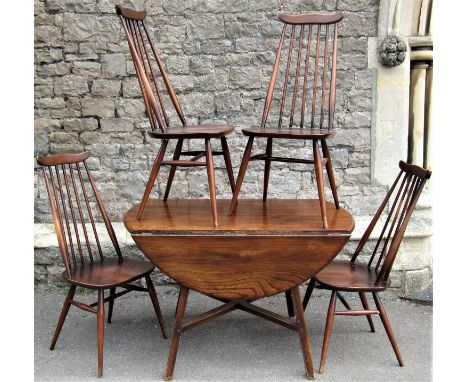 An Ercol dropleaf dining table on square cut supports together with a set of four Ercol stick back dining chairs 