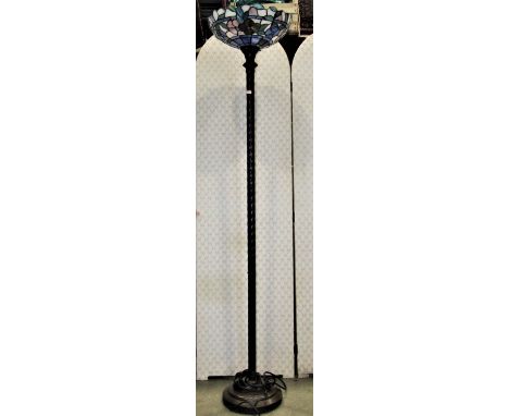 A contemporary lamp standard with spiral column support fitted with a leaded light shade 