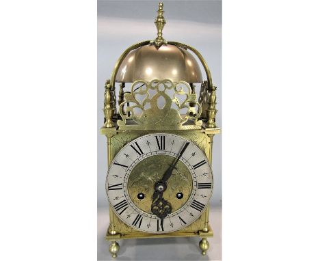 Brass cased antique style lantern clock with silvered chapter ring and engraved Roman numerals, 37 cm high, pendulum and key 