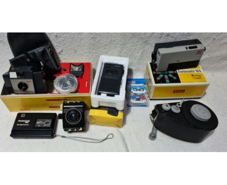 A box of cameras and accessories including Kodak Brownie 127, Kodak Instamatic M4 movie camera, Baby Brownie Special, Kodak D