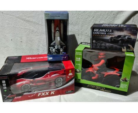 A boxed XQ Street FXX K RC car 1:12 scale, a boxed RC Kawasaki KFX 450R, a boxed M&amp;S Nasa space shuttle die-cast metal mo