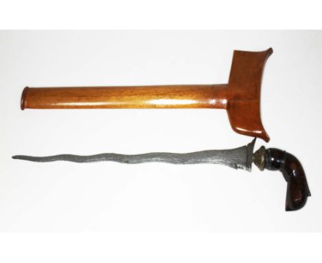 An eastern kris dagger and wooden scabbard, length 43cm.  