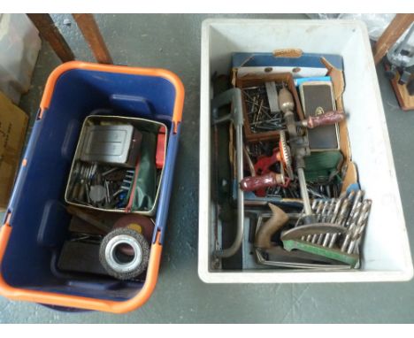 A box of vintage tools including hand drill, saws, and a large selection of drill bits, with tape measures 