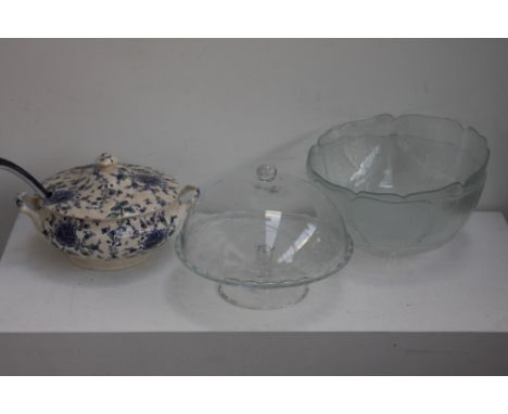 A quantity of glass to include a cake stand and cover of floral design, two large glass punch bowls, a large ceramic soup tur