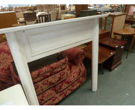 A white painted fire surround, with a pair of bed ends