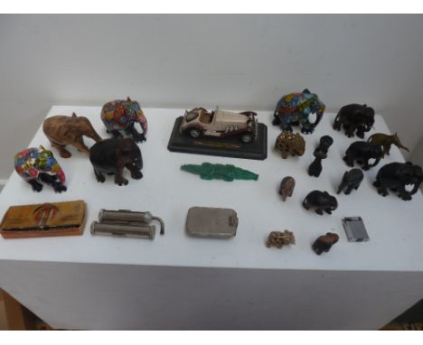 A mixed lot of carved elephants, a Mercedez Benz SSK model on plinth, an automatic blow lamp, and a jade crocodile