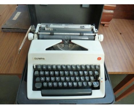 A vintage Olympia International typewriter in plastic carry case