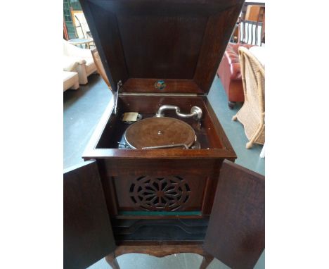 An Edwardian mahogany Dulcetto free standing Gramophone with record and speaker cabinet in working order with handle and spar