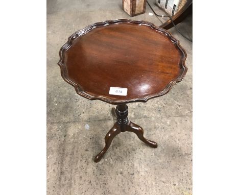 A reproduction mahogany tripod wine table