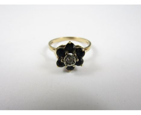 A vintage 9ct gold, diamond and sapphire flowerhead cluster dress ring, the central stone of approximately .03ct