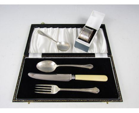 A silver spoon together with a silver napkin ring and a cased travelling cutlery set