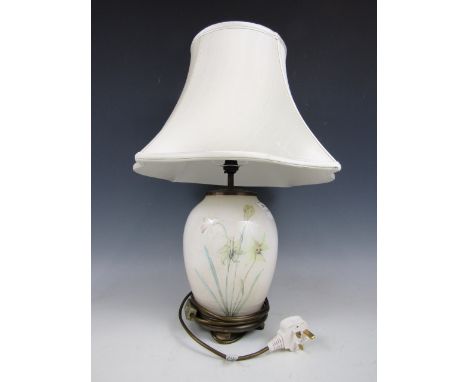 A contemporary ceramic lamp base decorated with daffodils