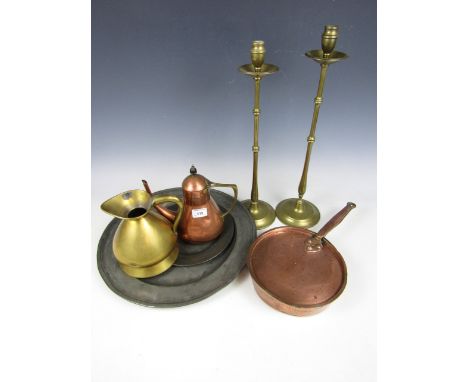 Two tall brass candlesticks together with a copper teapot, a brass quart measuring jug, a 19th century copper pan with cover 
