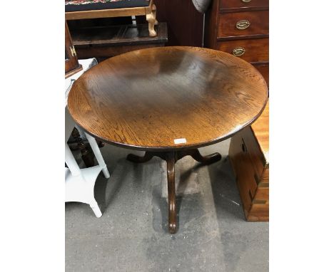 A reproduction oak snap top tripod breakfast table