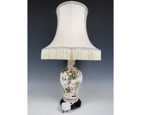 A ceramic lamp depicting butterflies and blossoms