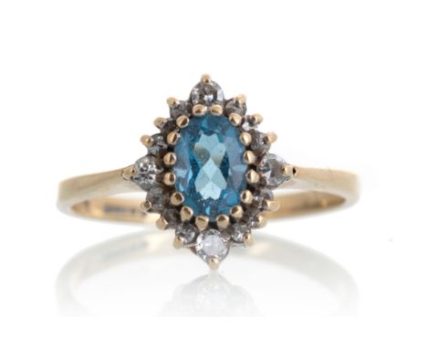 set with a central topaz surrounded by small diamonds, in nine carat gold, size K 1.6g