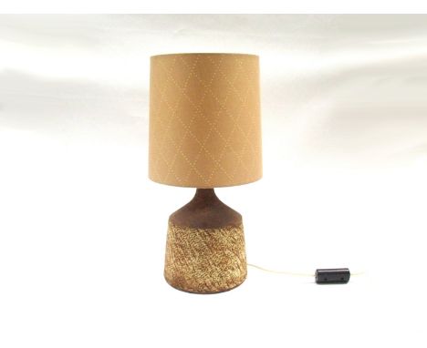 WAISTEL COOPER (1921-2003): A Studio Pottery lamp base with a textured glazed body. Signed to base. With a mocha coloured sha
