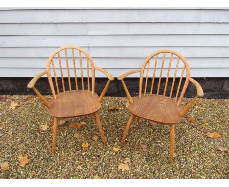 A pair of Ercol elm wood Windsor armchairs.