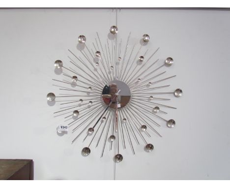 A metal sunburst style wall clock. 48cm diameter 